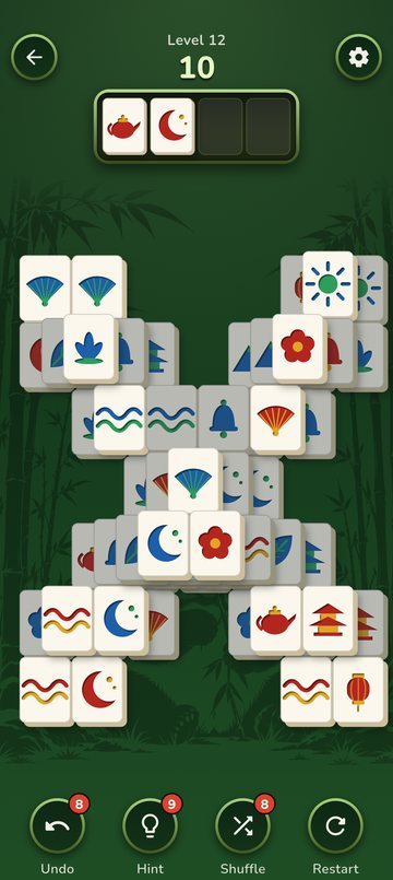 A Wood board with two tiles in the four-slot tray, and the Undo, Hint, Shuffle and Restart helpers